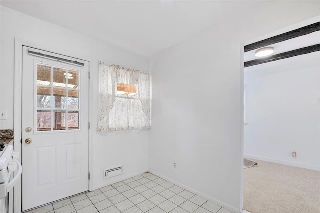 interior space with baseboards and light tile patterned floors