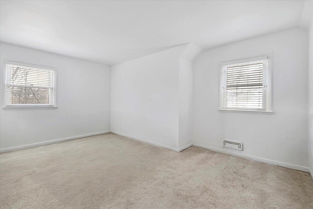 unfurnished room with baseboards, carpet flooring, and a healthy amount of sunlight