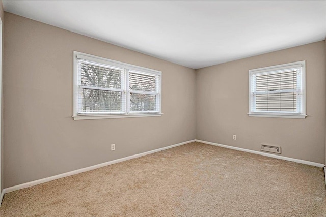 carpeted spare room with baseboards