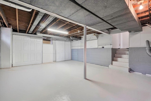 unfinished basement with concrete block wall