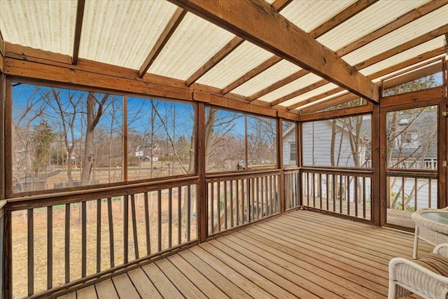 unfurnished sunroom featuring lofted ceiling