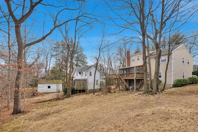 view of yard featuring stairs, a residential view, and a deck