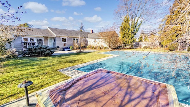 view of pool featuring a yard, a fenced in pool, and a patio