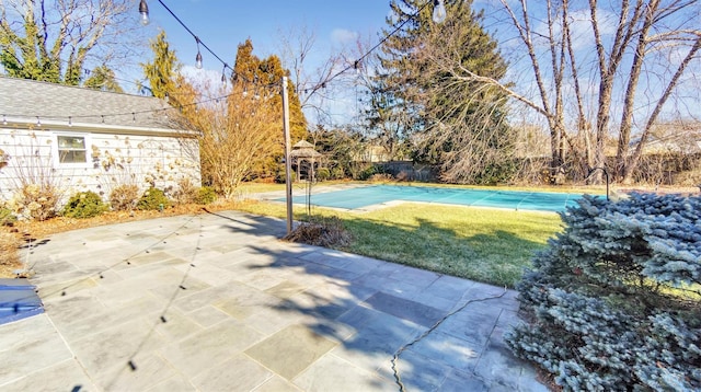 view of sport court with a yard and fence