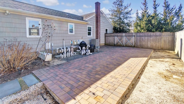 view of patio with a fenced backyard and central air condition unit