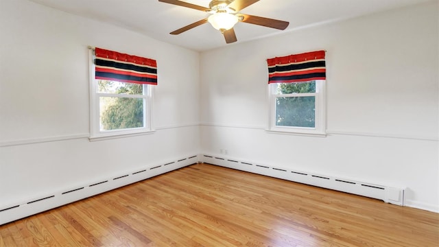 unfurnished room with a ceiling fan, a baseboard heating unit, and wood finished floors