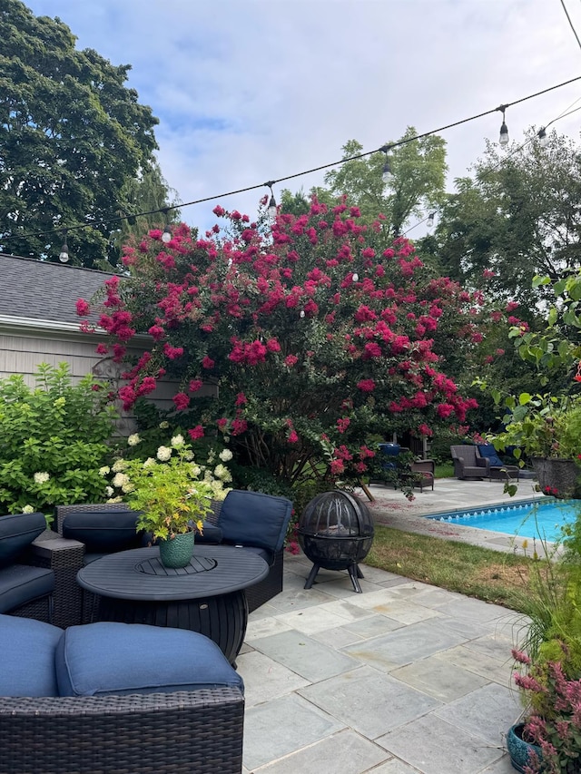 view of patio / terrace featuring an outdoor fire pit