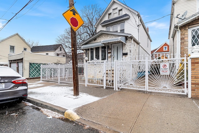 view of front of property with a fenced front yard and a gate