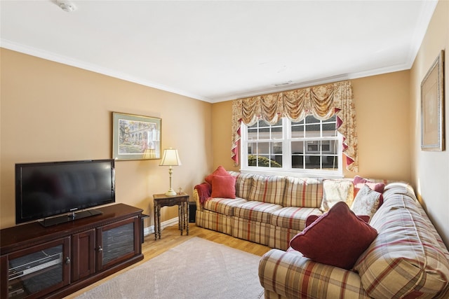 living area with crown molding, baseboards, and wood finished floors