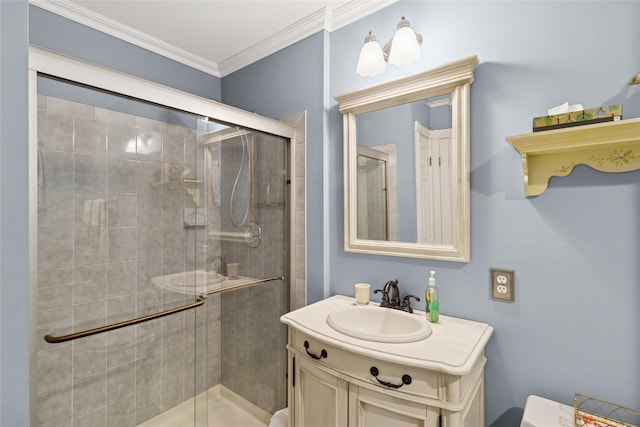 full bathroom featuring a stall shower, crown molding, and vanity