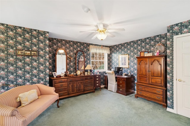 interior space with a ceiling fan, carpet, and wallpapered walls