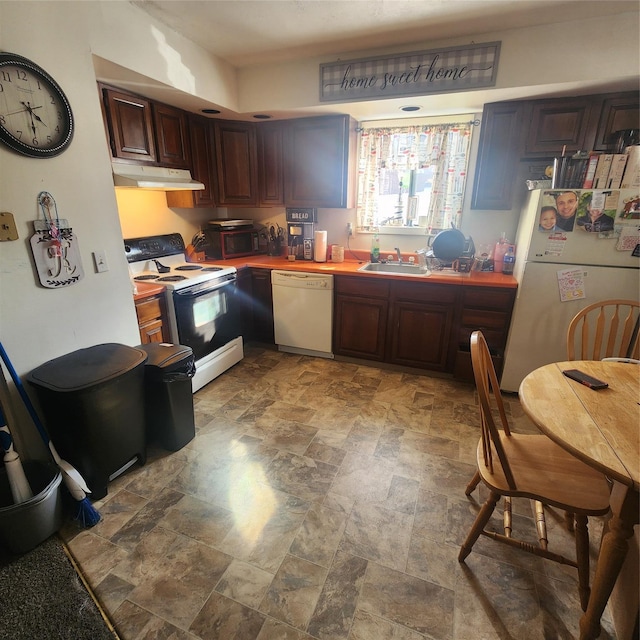 kitchen featuring white appliances, under cabinet range hood, light countertops, and a sink