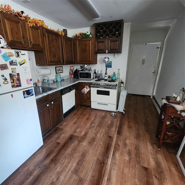 kitchen featuring dark brown cabinetry, white appliances, and dark wood-style flooring