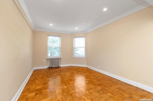 empty room with radiator heating unit, baseboards, crown molding, and recessed lighting