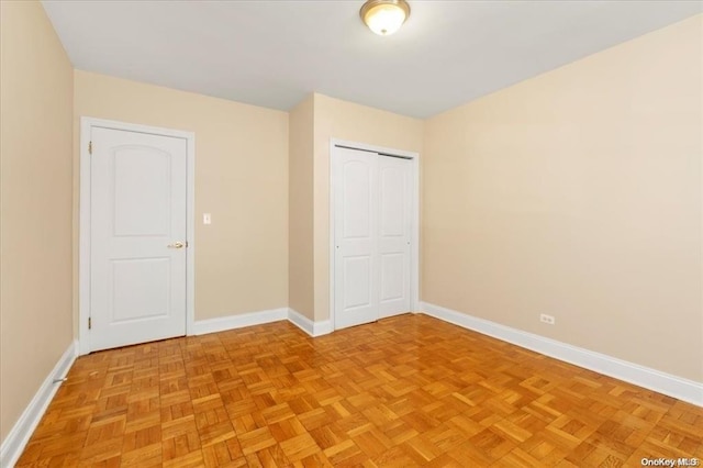 unfurnished bedroom featuring a closet and baseboards