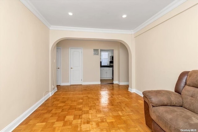 interior space featuring arched walkways, crown molding, recessed lighting, and baseboards