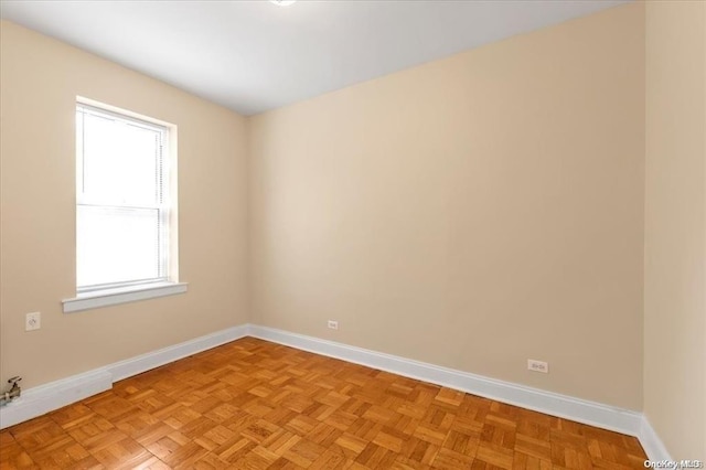 spare room featuring baseboards