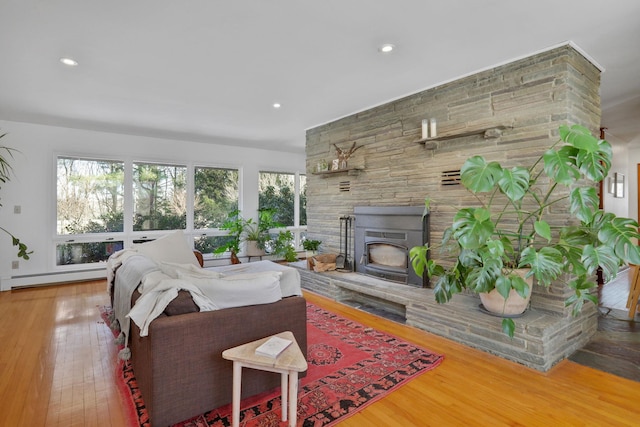 living area with recessed lighting, baseboard heating, and wood finished floors