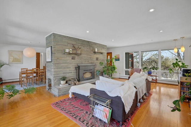 living room with a baseboard radiator, a baseboard heating unit, wood finished floors, and recessed lighting