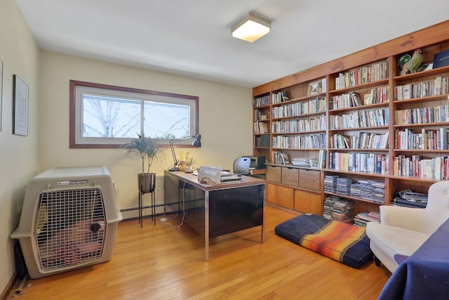 office featuring light wood-type flooring and a baseboard heating unit