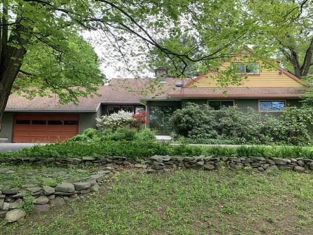 view of front of property with a chimney and an attached garage