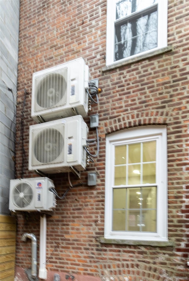 exterior details with ac unit and brick siding