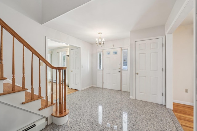 entrance foyer with baseboards, a baseboard radiator, stairway, granite finish floor, and a chandelier