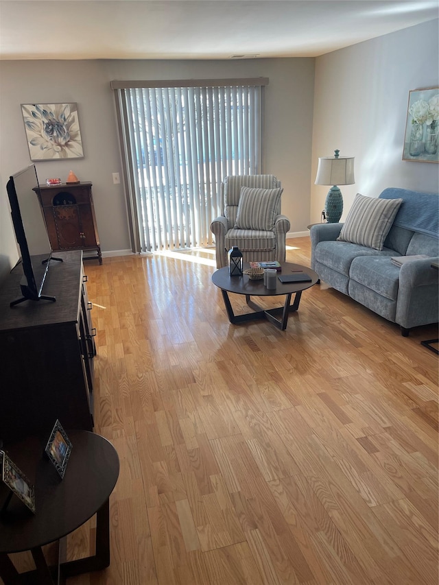 living room with light wood-style flooring and baseboards