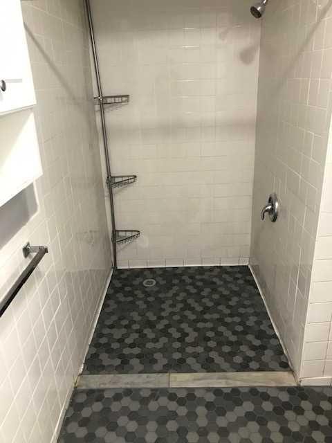 full bathroom with a tile shower