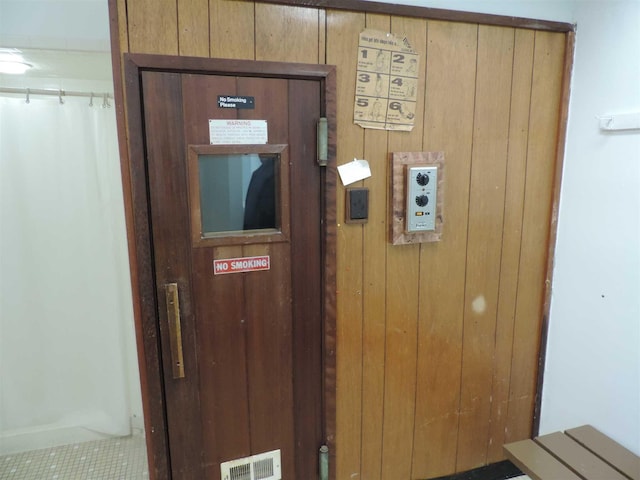 room details featuring wooden walls and visible vents