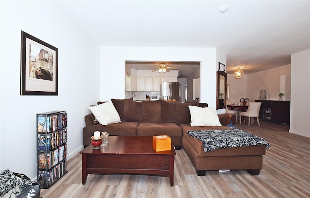 living area with baseboards and light wood finished floors