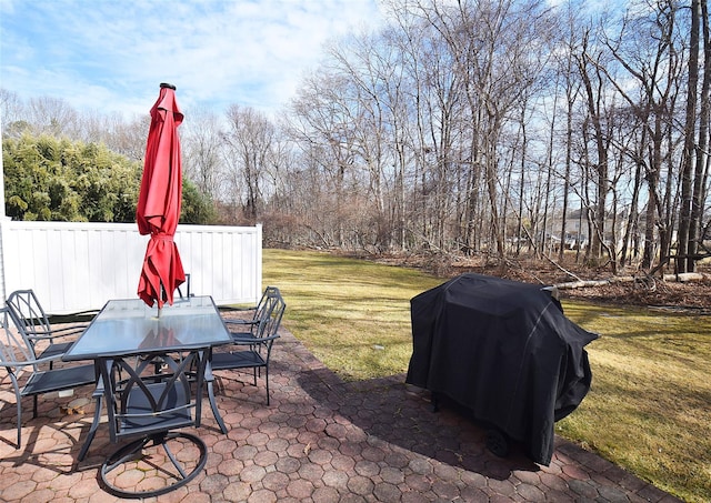 view of patio featuring fence, area for grilling, and outdoor dining space