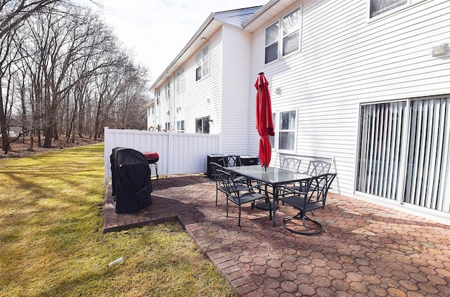 view of patio / terrace with a grill and fence