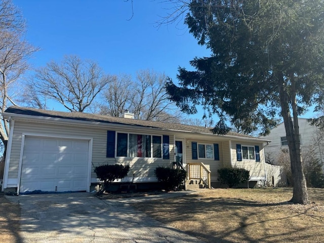 ranch-style home featuring an attached garage, driveway, and a chimney