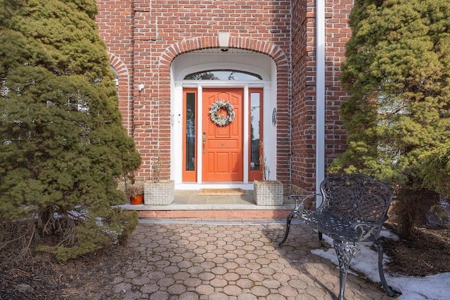 entrance to property with brick siding