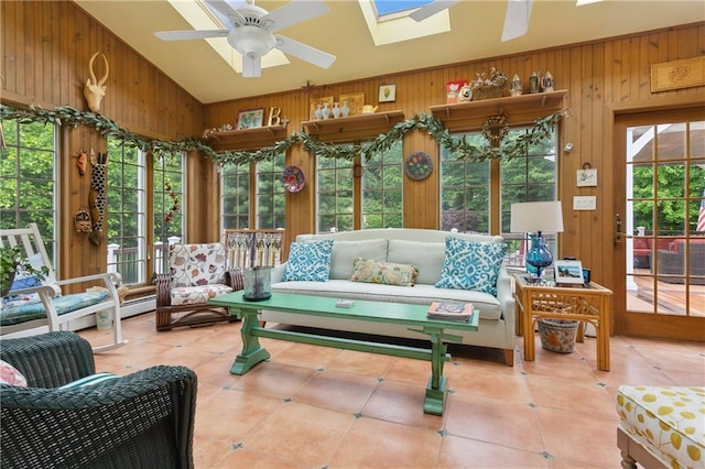 sunroom with ceiling fan and lofted ceiling with skylight