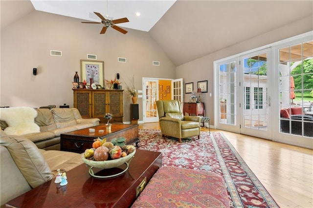 living room with light wood-style flooring, visible vents, and french doors