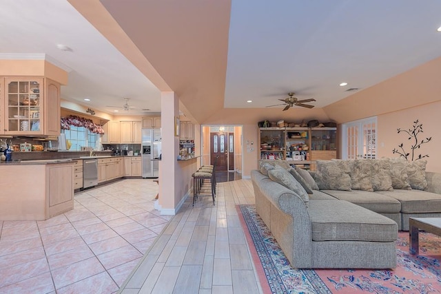 living room with ceiling fan, recessed lighting, visible vents, baseboards, and vaulted ceiling