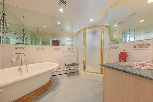 bathroom featuring a baseboard heating unit, visible vents, a shower stall, and vanity