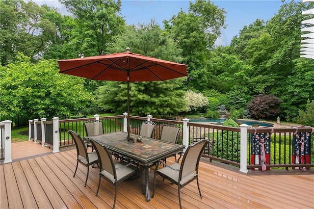 deck with outdoor dining area and an outdoor pool