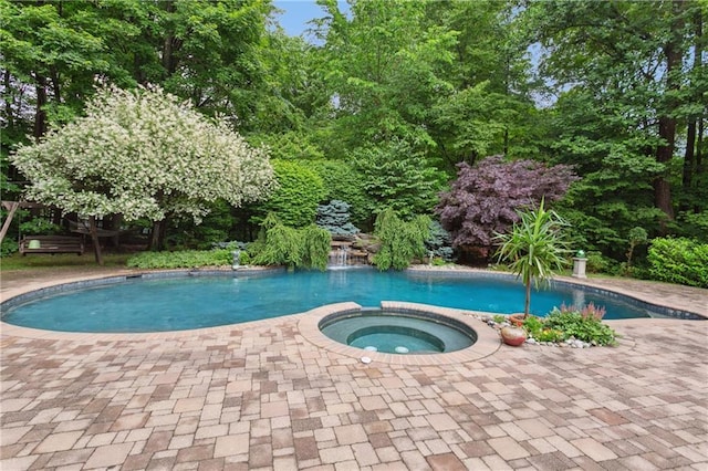 view of swimming pool with a pool with connected hot tub