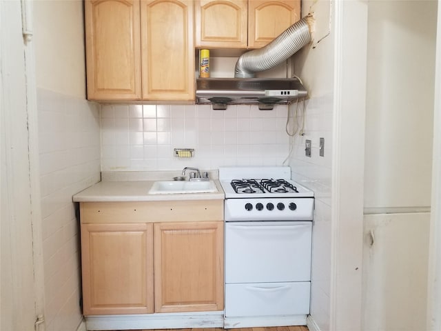 111-16 66th Ave Unit 3C, Forest Hills, NY 11375 - kitchen featuring white gas range, light countertops, light brown cabinetry, under cabinet range hood, and a sink