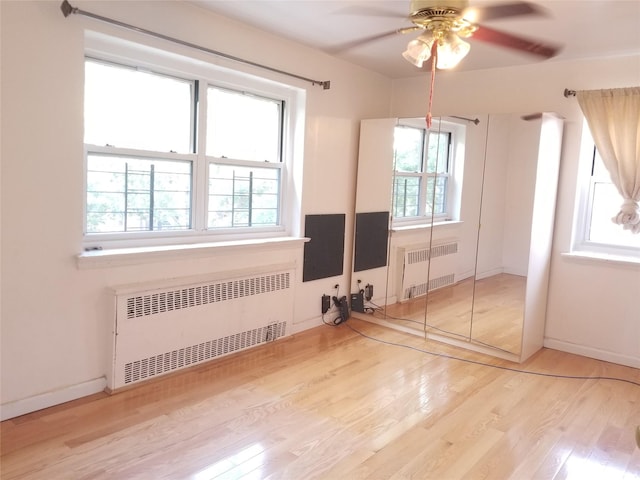 111-16 66th Ave Unit 3C, Forest Hills, NY 11375 - unfurnished bedroom with radiator, light wood-style flooring, baseboards, and ceiling fan