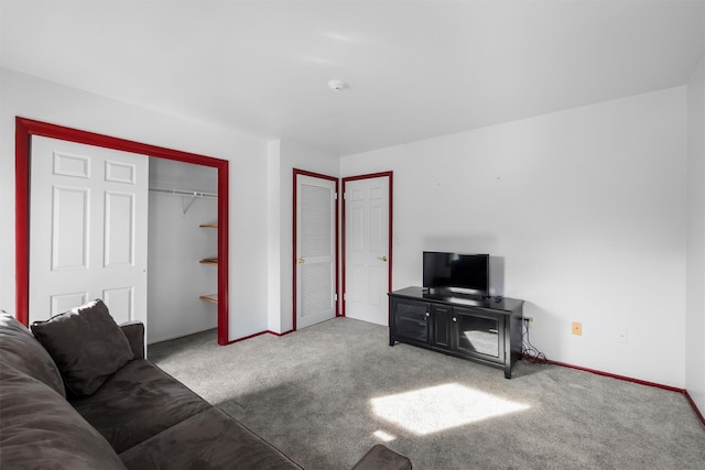 living area with baseboards and carpet flooring