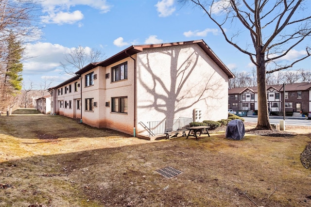 view of property exterior with a residential view and stucco siding