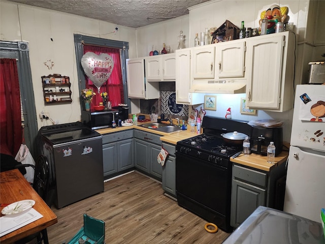 kitchen with under cabinet range hood, a sink, white cabinets, gray cabinets, and black appliances