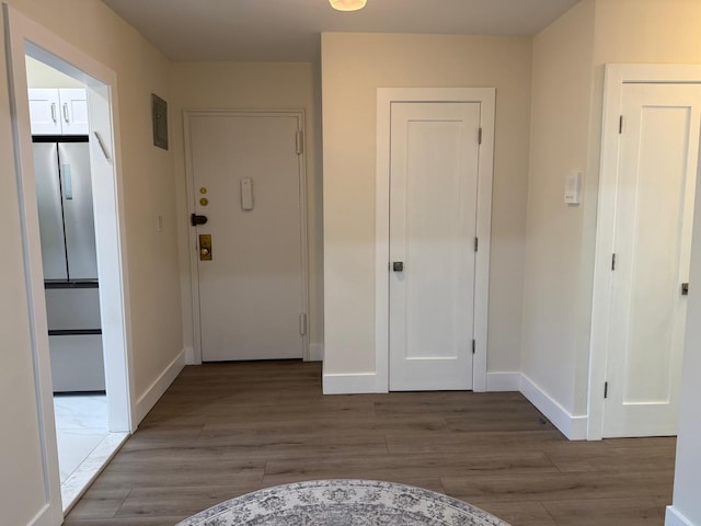 hall featuring baseboards and wood finished floors