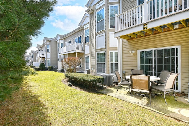 view of yard with a residential view, cooling unit, and a patio