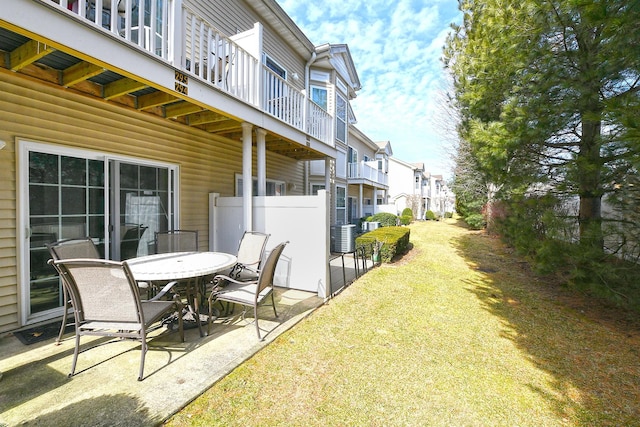 view of yard featuring a patio area, cooling unit, and outdoor dining space