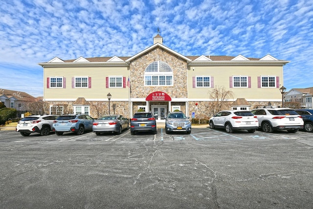 view of property with uncovered parking